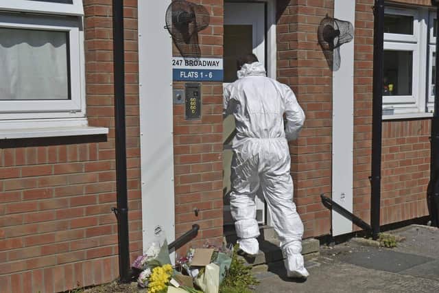 A forensics officer outside the block of flats in Broadway.