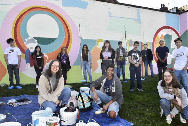 Pictured at front are artists, Sabrina Rodi, Natasha Joseph and Franscesca Rodi from 'We Belong Here' with volunteers from Leeds Youth Services with the 'Memory Bank Mural'
Photo: Steve Riding