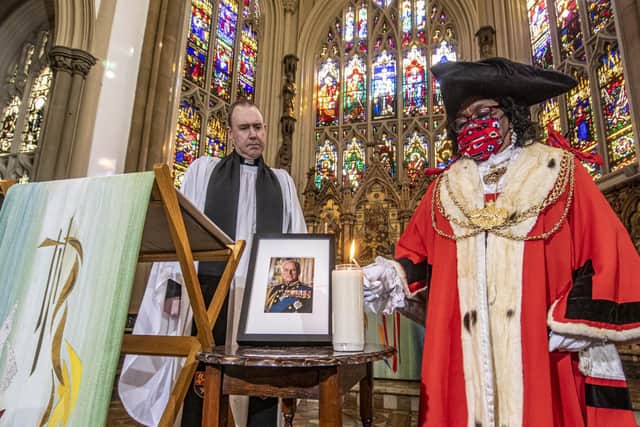 Rev Sam Corley, Rector of Leeds Minster watches The Lord Mayor of Leeds Eileen Taylor light a candle. Picture Tony Johnson