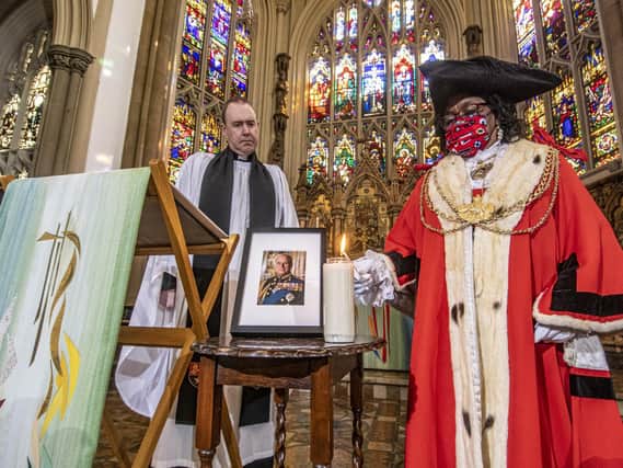Rev Sam Corley, Rector of Leeds Minster watches The Lord Mayor of Leeds Eileen Taylor light a candle. Picture Tony Johnson
