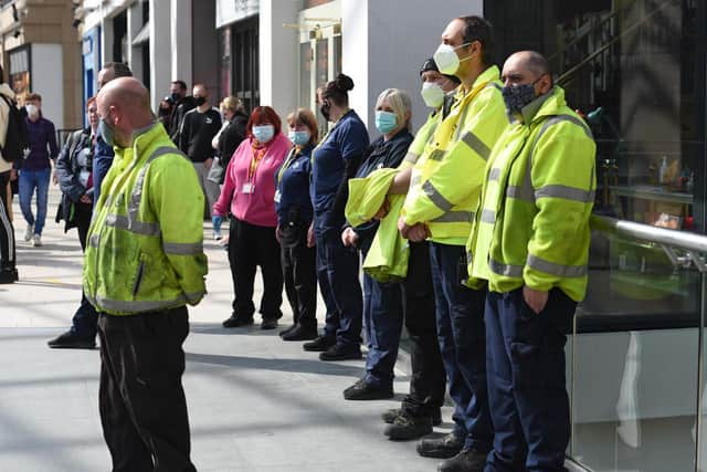 Staff at Trinity Leeds pause for a minute's silence on Saturday.