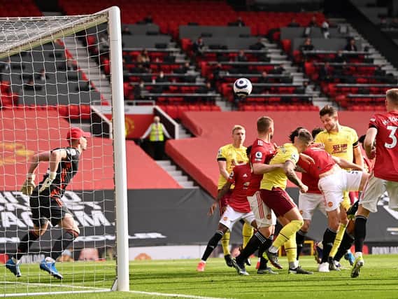 James Tarkowski of Burnley scores his team's first goal during the Premier League match between Manchester United and Burnley at Old Trafford on April 18, 2021 in Manchester, England.