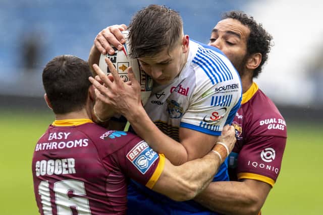 NO WAY THROUGH: Leeds Rhinos youngster Sam Walters is tackled by Huddersfield Giants' Leroy Cudjoe and Jack Cogger. Picture: Tony Johnson.
