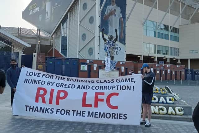 FANS UNITED - Liverpool fans hold up a banner in protest at their club's European Super League plans, outside Elland Road where Leeds United supporters are also gathering to protest.