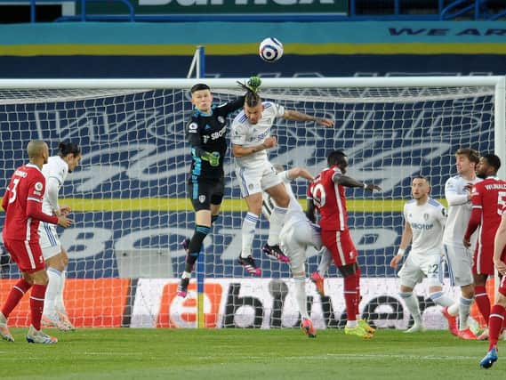 PRESSURE: Leeds United's Illan Meslier and Kalvin Phillips rise high to clear another Liverpool attack. Picture by Simon Hulme.