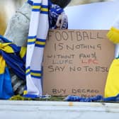 Signs left outside Leeds United's Elland Road stadium as football fans gathered to protest against European Super League plans.