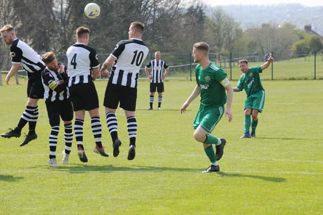 Jake Topp, of Beeston St Anthony, hits his free kick over the Hall Green wall. Picture: Steve Riding.