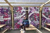 Street artist Nicolas Dixon with his new mural at Chow Down festival