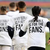 Leeds United players wear 'Football Is For The Fans' shirts during the warm up prior to the Premier League match against Liverpool. Picture: Clive Brunskill/PA Wire.