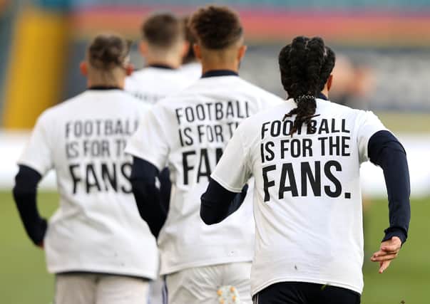 Leeds United players wear 'Football Is For The Fans' shirts during the warm up prior to the Premier League match against Liverpool. Picture: Clive Brunskill/PA Wire.