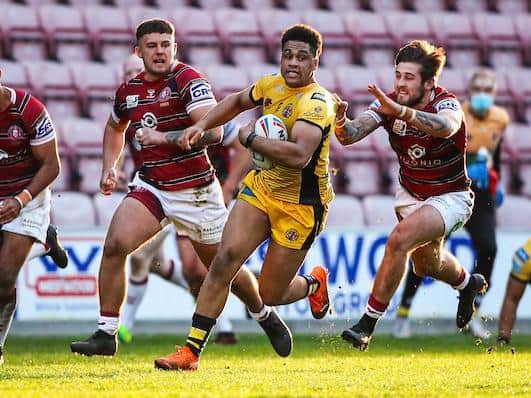 Derrell Olpherts makes a break against Wigan. Picture by Alex Whitehead/SWpix.com.