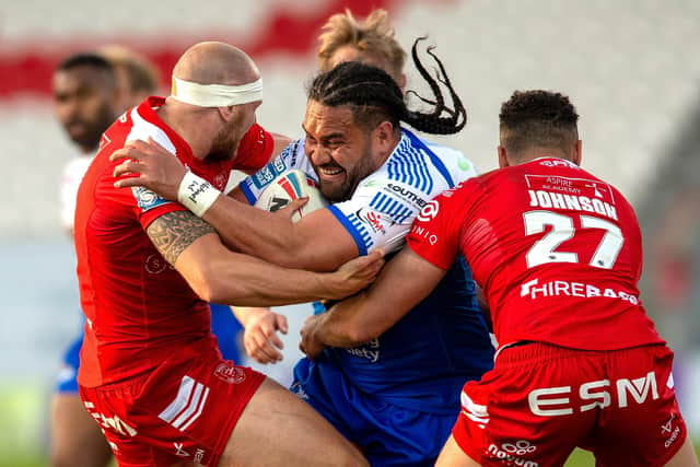 Held: Leeds' Konrad Hurrell is tackled by Dean Hadley and Luis Johnson. Picture: Bruce Rollinson