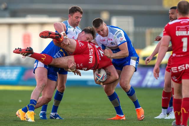 Got him: Rovers' hat-trick hero Kane Linnett is stopped by the Rhinos' James Donaldson and Mikolaj Oledski.
Picture Bruce Rollinson