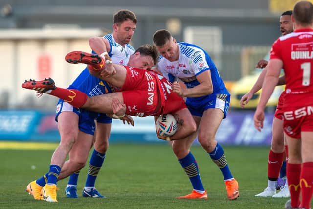 Got him: Rovers' hat-trick hero Kane Linnett is stopped by the Rhinos' James Donaldson and Mikolaj Oledski.
  Picture Bruce Rollinson