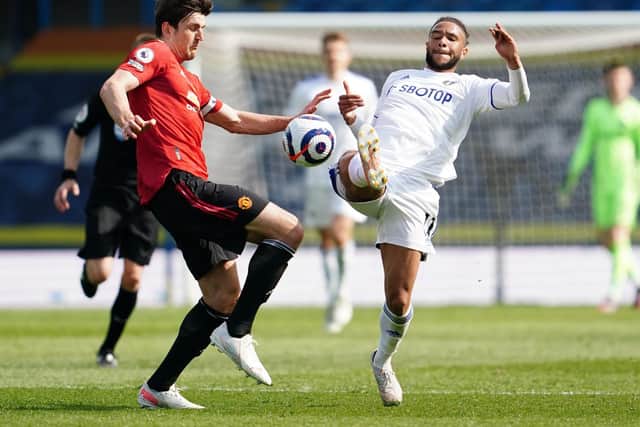 BOOKING: For Manchester United captain Harry Maguire, left, after catching Leeds United forward Tyler Roberts, right. Photo by Jon Super - Pool/Getty Images.