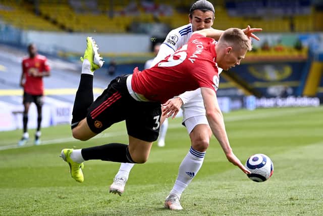 Manchester United's Scott McTominay takes a tumble under pressure from Leeds United man-of-the-match contender Pascal Struijk. Picture: Laurence Griffiths/PA Wire.