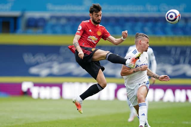 ON THE SCENE: Leeds United's England international midfielder Kalvin Phillips, right, challenges Manchester United star Bruno Fernandes, left, in Sunday's goalless draw at Elland Road. Photo by JON SUPER/POOL/AFP via Getty Images.