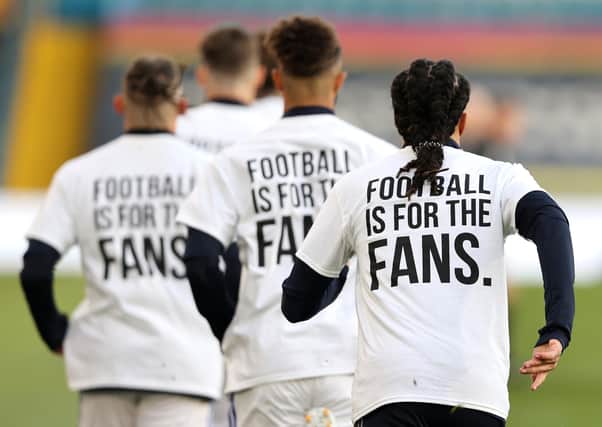 Leeds United players wearing 'Football Is For The Fans' shirts during the warm up prior to kick-off during the Premier League match agaimnst Liverpool (Picture: PA)