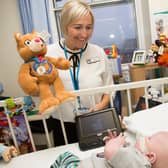 Lisa from Leeds Congenital Heart Unit handing out a Katie bear teddy to baby Oscar.