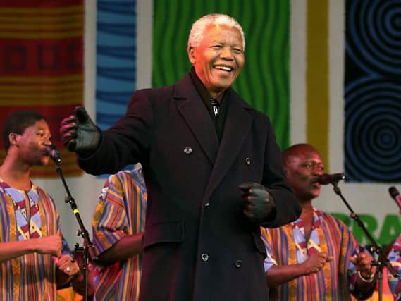 Former South African president Nelson Mandela joins in the dancing on stage with Ladysmith Black Mambazo at the Millennium Square in Leeds where he was made an honorary freeman during his first visit to the north of England. PA Archives