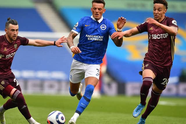 FAMILIAR FACE: Brighton's former Whites loanee Ben White, centre, strides on as Leeds United duo Jack Harrison, left, and Rodrigo, right, look to challenge. Photo by BEN STANSALL/POOL/AFP via Getty Images.