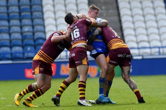 Leeds Rhinos' Liam Sutcliffe is held up by the Huddersfield Giants defence. Picture: Simon Hulme/JPIMedia.