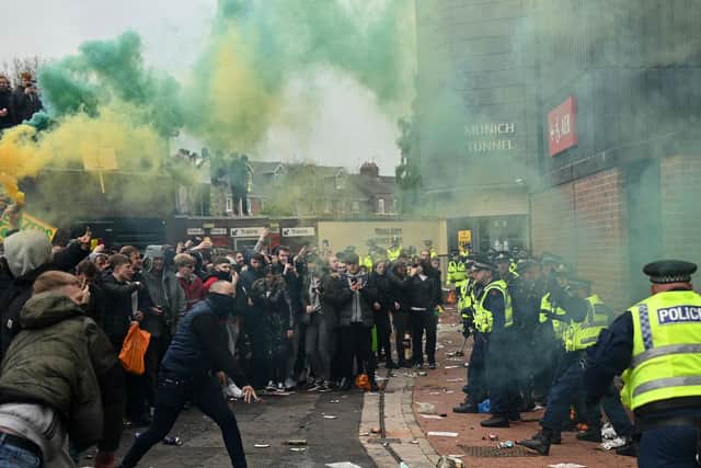UGLY SCENES: At Old Trafford as fans protest against Manchester United's Glazer family ownership and clash with police. Photo by OLI SCARFF/AFP via Getty Images.