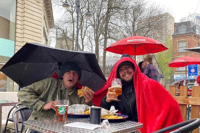 Two men defying the weather and tucking into their beer and gyros at Tavassoli's Cafe + Grill. Photo credit: Tavassoli's Cafe + Grill
