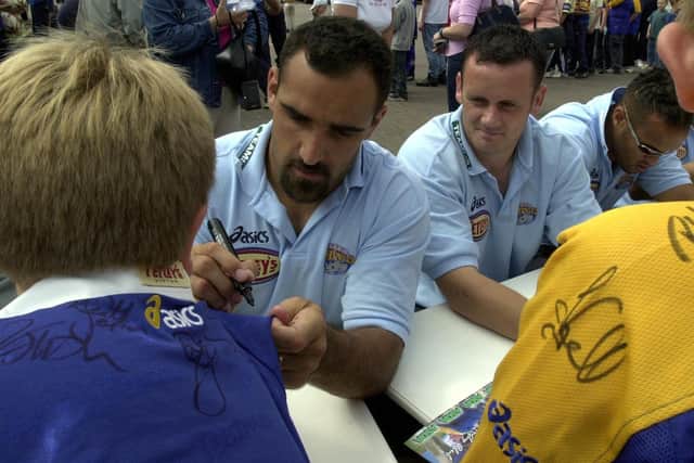 Tonie Carroll, left, and Francis Cummins sign autographs during a Leeds Rhinos meet-the-players' day in August 2002. Picture: Mark Bickerdike/JPIMedia.