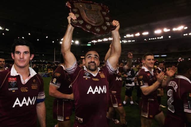 Queensland's Tonie Carroll lifts the Harvey Norman State of Origin Shield after victory over New South Wales in July 2006. Picture: Adam Pretty/Getty Images.