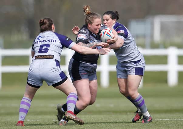 Featherstone Rovers Women's Andrea Dobson, right, and Katherine Hepworth tackle Castleford Tigers' Rhiannon Marshall. Dobson will miss Rovers clash with Leeds today due to a head injury. Picture: Ed Sykes/SWpix.com.