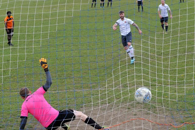 Brandon Stansfield, of FC  Scholes, scores from the penalty spot past Beck & Call FC goalkeeper Mike Smith. Picture: Steve Riding.