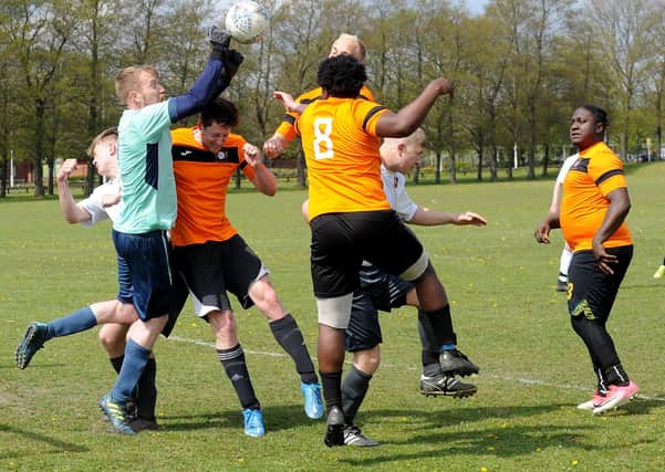 FC  Scholes goalkeeper Paul Rennison punches bravely against Beck & Call FC striker Jamie Halshaw during Sunday's Leeds Combination Division 2 encounter. Picture: Steve Riding.
