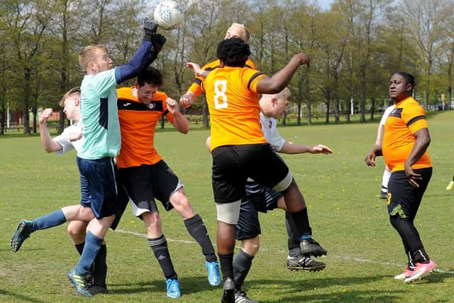 FC  Scholes goalkeeper Paul Rennison punches bravely against Beck & Call FC striker Jamie Halshaw during Sunday's Leeds Combination Division 2 encounter. Picture: Steve Riding.