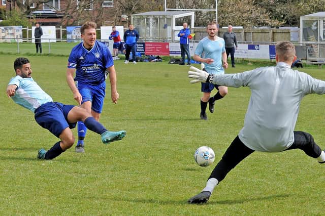 Danny Lyons, of Farsley Celtic Juniors, battles through to score against Alwoodley. Picture: Steve Riding.
