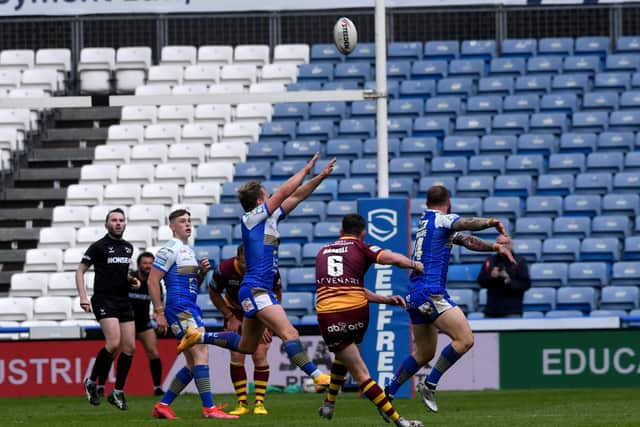 Lee Gaskell kicks the winning drop goal for Huddersfield Giants against Leeds Rhinos. Picture: Simon Hulme.