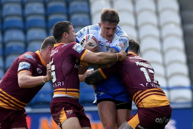 Leeds Rhinos' Liam Sutcliffe breaks through the Huddersfield defence. Picture: Simon Hulme.