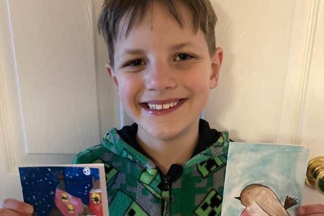 James with two of the cards he created that were sold at The Tetley over Christmas and will feature in the Superheroes project.
