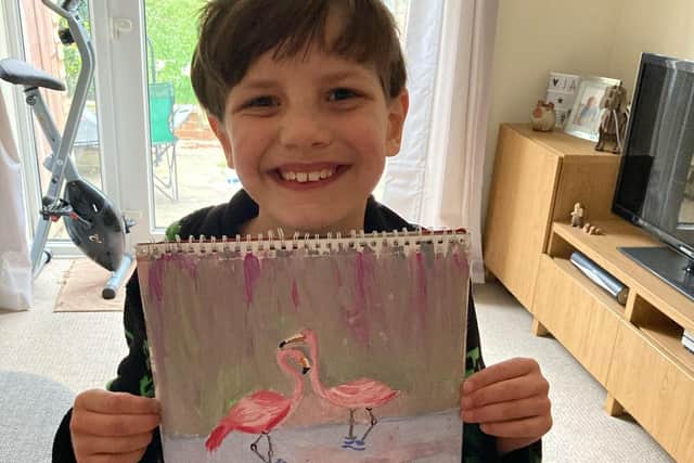 Budding young artist, eight year old James Tortice with another piece of his work.