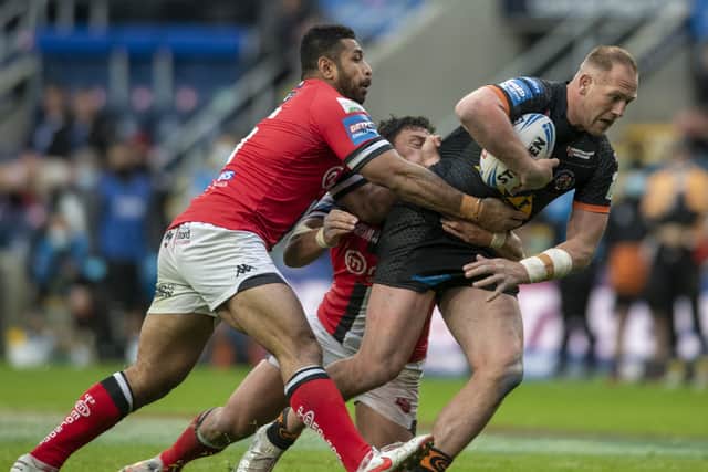 HARD YARDS: Liam Watts runs at Salford's Sebastine Ikahihifo and Elijah Taylor. Picture: Tony Johnson.