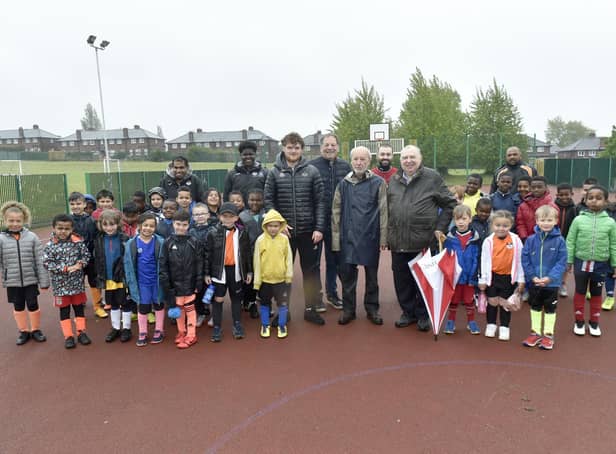 Pictured: Jake Boyd, centre left, football coach, with Freemasons Phil Fraser, Michael Rose, Alex Ullmann, Raymond Diamond from The Lodge of Dawn, Headingley, and kids from the centre. Picture: Steve Riding