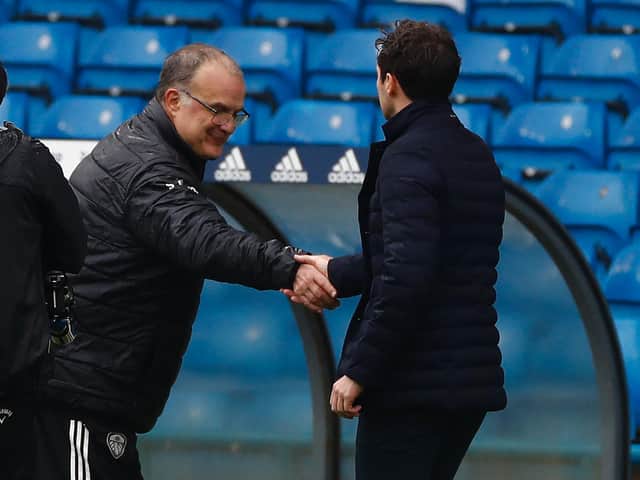 HAILING DISTANCE: Leeds United head coach Marcelo Bielsa greets Tottenham boss Ryan Mason before Saturday's clash at Elland Road which left the Whites six points behind Spurs. Photo by JASON CAIRNDUFF/POOL/AFP via Getty Images.