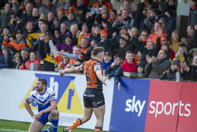Jake Trueman celebrates with Tigers' fans after scoring agianst St Helens in March, 2020. Picture by Tony Johnson.