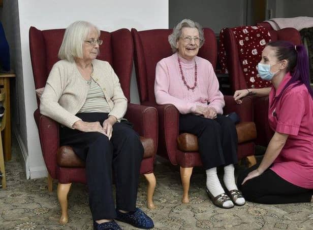 Alexandra Court care home care assistant Sam Maybury chats to residents Audrey Sykes, 86, and Vivienne Aitkin, 91, before their first Covid-19 vaccinations. Photo; Steve Riding