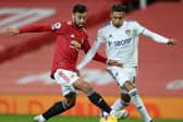 Manchester United's Bruno Fernandes battles with Leeds United's Raphinha. Pic: Getty