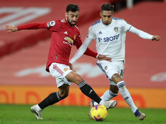 Manchester United's Bruno Fernandes battles with Leeds United's Raphinha. Pic: Getty