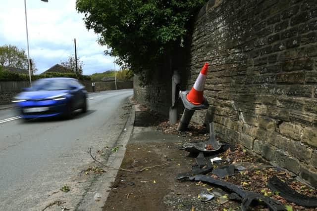 Detritus from previous collisions is clearly visible in the road