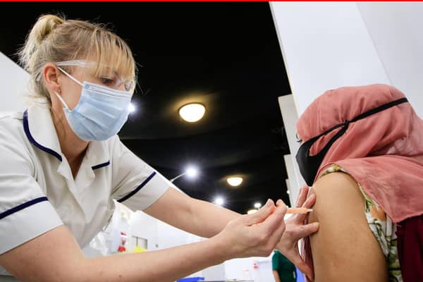 A woman receives an injection of the coronavirus vaccine at Elland Road vaccine centre in Leeds (photo: PA Wire/ Danny Lawson)