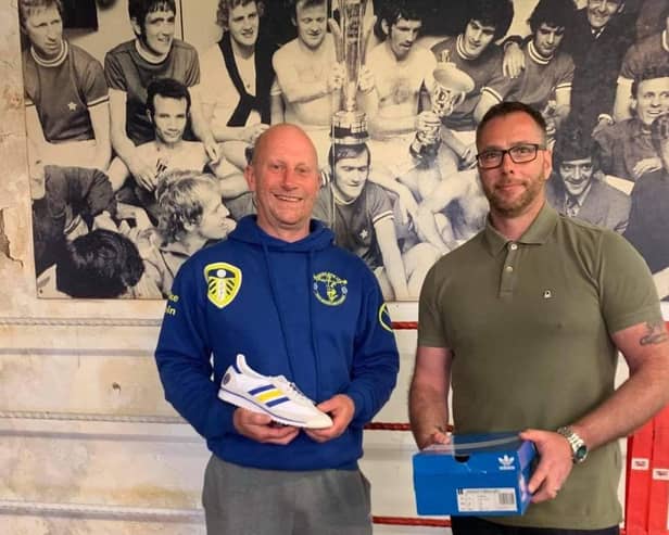 Craig Chapman of The Pool the Presenting Mike Tobin with the custom made trainers