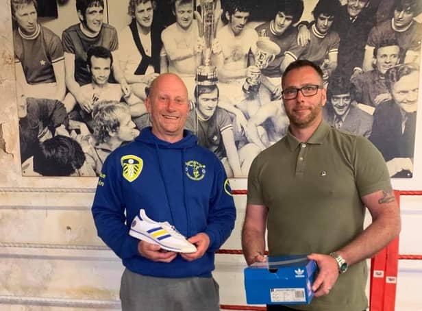 Craig Chapman of The Pool the Presenting Mike Tobin with the custom made trainers